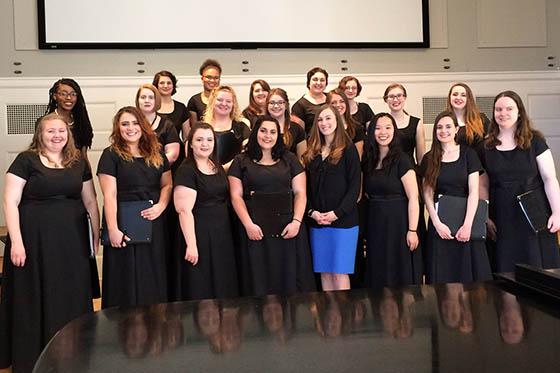 Photo of the Chatham Choir all wearing black, posing together for a photo